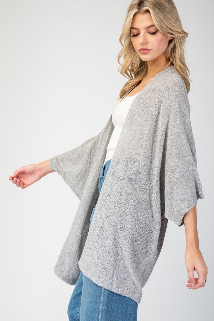 Kimono Style slouchy cardigan with short dolman sleeves made in knit fabric that's as comfy as your favorite pajamas, but way more stylish! This versatile piece drapes beautifully over any outfit, adding that perfect touch of a classic fit and look.  model wearing gray with jeans