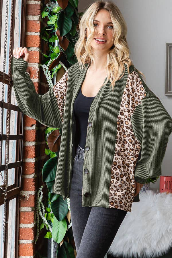 olive green ribbed cardigan with 4 dark green buttons starting just below the chest area with a panel of leopard print down the front panel on both sides.   an oversized cardigan.