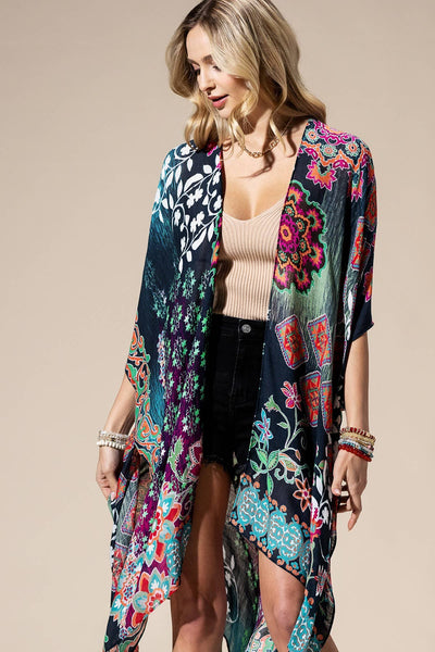 Lightweight kimono with a colorful mix of floral prints. The rich blend of teal, magenta, green, and orange hues over a dark base creates a unique, artistic look