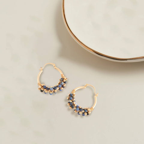 gold hoop beaded earrings. the hoops are small