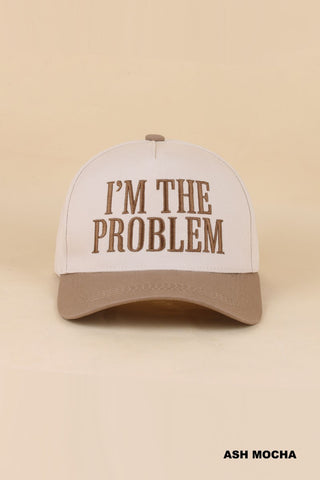 light brown bill baseball style cap that says "I'm the problem"