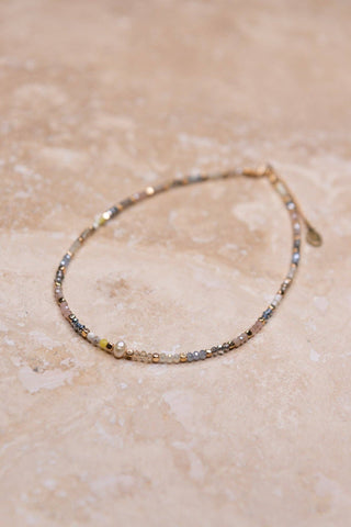 Adjustable, multi color beaded choker with pearl bead in center. 16" long