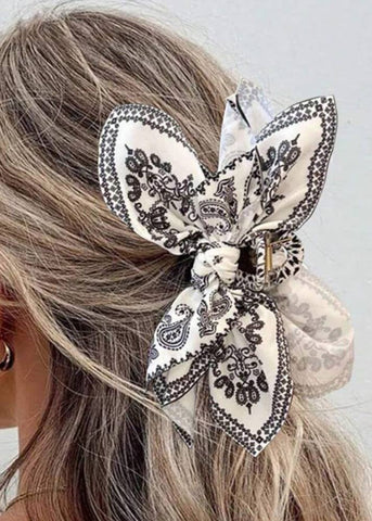 white and black bow hair clip with some paisley print 