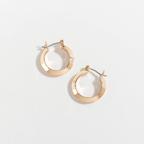 Gold hoop earrings on a light gray background