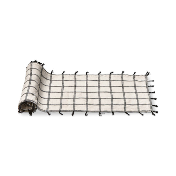 This white and black 100% cotton runner is slub woven with self tassles in black 