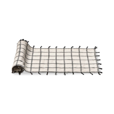 This white and black 100% cotton runner is slub woven with self tassles in black 