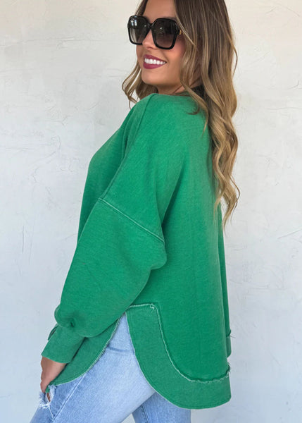 oversized green washed look sweatshirt, shoulders are off set and raised hemline