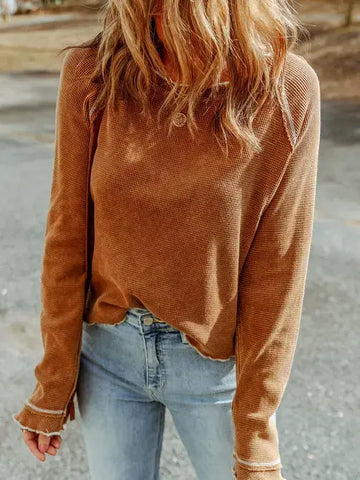 Camel color waffle textured top slightly longer sleeved adorned with white raised thread.